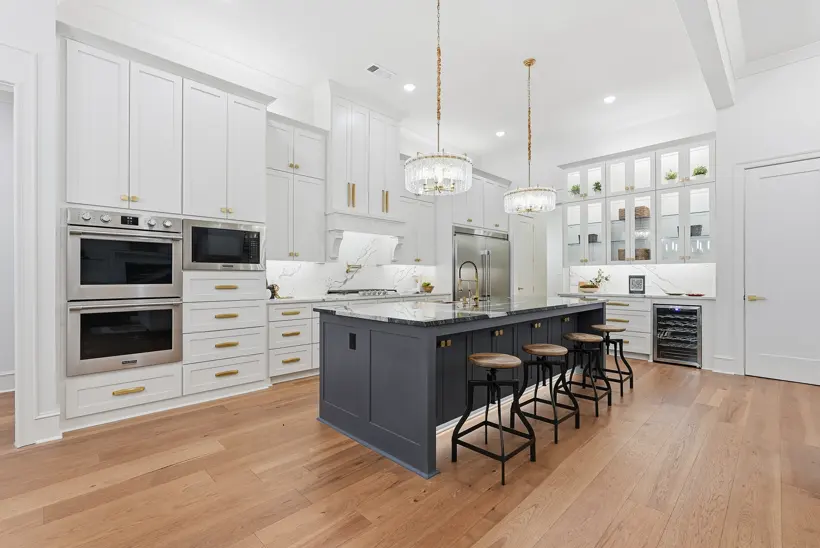 Bright white kitchen with a dark island
